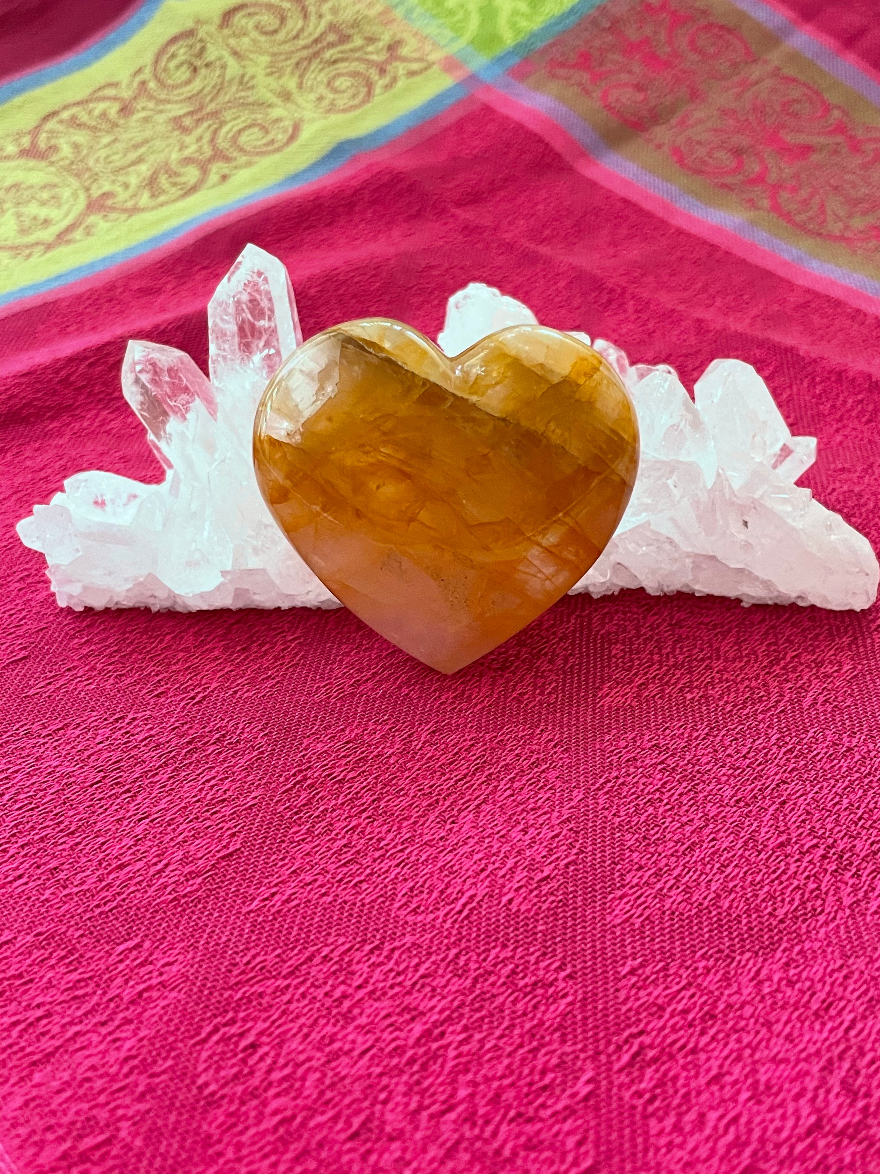 Reverse side. Beautiful citrine heart! Great to place on your altar or bookshelf, to hold during meditation, to use for healing or as a décor item in your home of office. Citrine absorbs and dispels negative energy, is a stone of abundance - attracting money, prosperity and success, is warming & energizing, enhances creativity, brings a positive attitude, is cleansing and more. This citrine heart is approximately 2" at it's widest expanse. Cost $22.