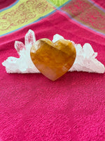 Load image into Gallery viewer, Reverse side. Beautiful citrine heart! Great to place on your altar or bookshelf, to hold during meditation, to use for healing or as a décor item in your home of office. Citrine absorbs and dispels negative energy, is a stone of abundance - attracting money, prosperity and success, is warming &amp; energizing, enhances creativity, brings a positive attitude, is cleansing and more. This citrine heart is approximately 2&quot; at it&#39;s widest expanse. Cost $22.
