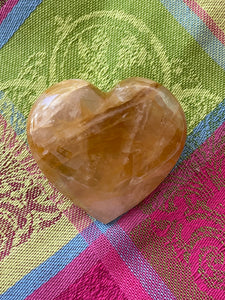 Alternate view/front. Beautiful citrine heart! Great to place on your altar or bookshelf, to hold during meditation, to use for healing or as a décor item in your home of office. Citrine absorbs and dispels negative energy, is a stone of abundance - attracting money, prosperity and success, is warming & energizing, enhances creativity, brings a positive attitude, is cleansing and more. This citrine heart is approximately 2" at it's widest expanse. Cost $22.
