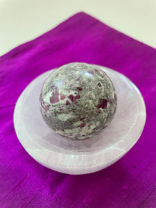 Alternate view. Ruby in matrix sphere is perfect for your altar, for meditation, as décor in your home or office. It consists of rubies set in their natural stone matrix or base. Ruby balances the heart, increases energy levels. It is a stone of love and passion and sexuality. It protects against psychic attack. It is a stone of prosperity and helps you to draw in abundance and maintain wealth. It enhances courage and leadership & more. This sphere weighs 5.2 oz. Approx. 6" in circumference. $36.00.