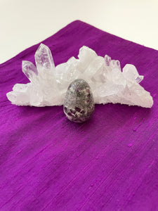 Alternate view. This gorgeous ruby in matrix egg is perfect for your altar, for healing, to hold during meditation, or as décor in your home or office. It consists of rubies set in their natural stone matrix or base. Ruby balances the heart & increases energy levels. It is a stone of love and passion and sexuality. It protects against psychic attack. It is a stone of prosperity and it also enhances courage and leadership and much more. This sphere weighs 3.1 oz and is approximately 1½" tall. Cost $9.