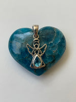 Load image into Gallery viewer, Alternate view. Dainty sterling silver angel pendant with stunning teardrop blue topaz. Blue topaz soothes &amp; relaxes, is a stone of love and manifestation, verbal communication, emotional support and more. The angel reminds us that we are being watched over, always! Pendant is approximately 1&quot; long. Cost is $18.00.
