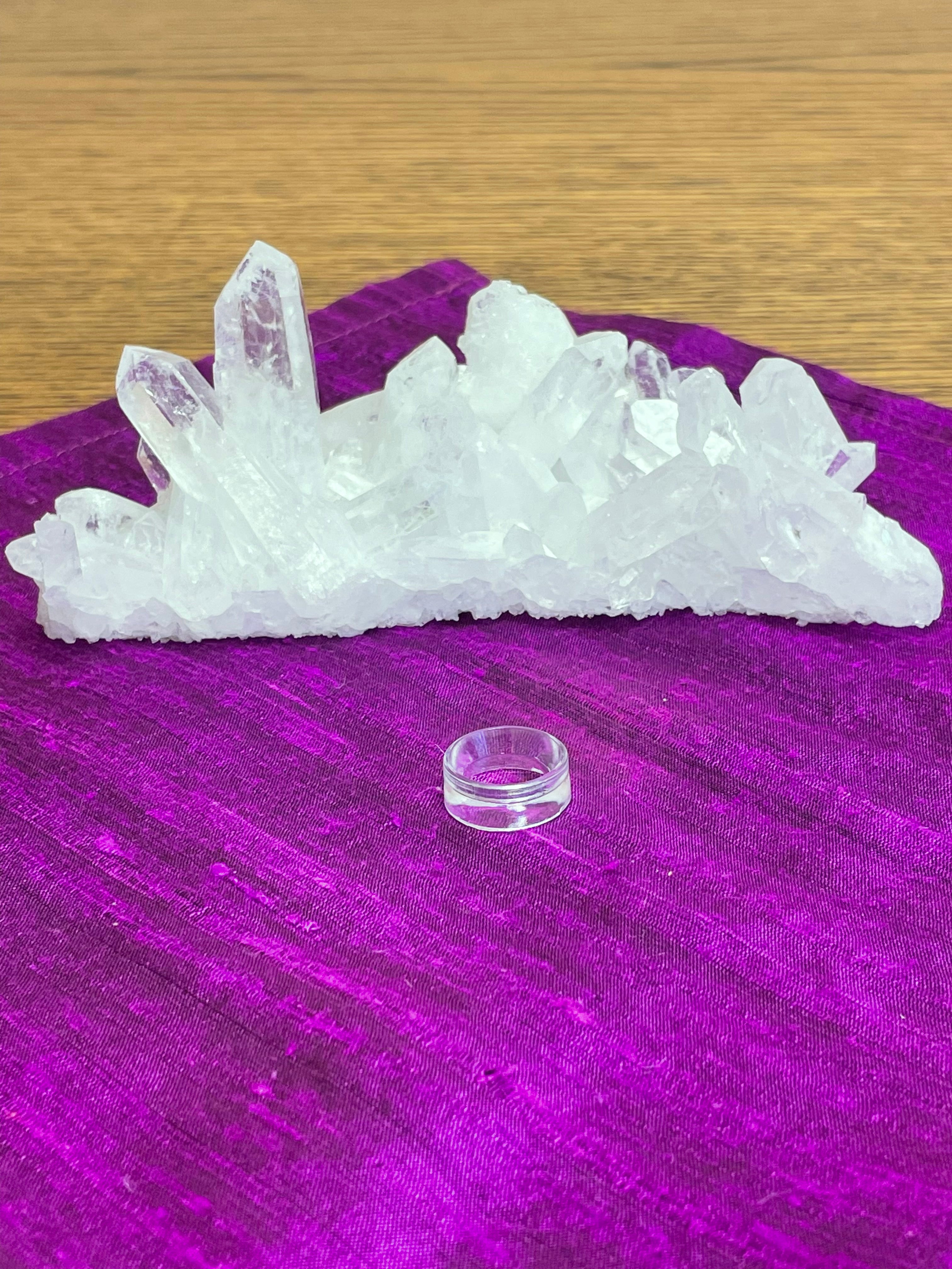 Your basic clear plastic ring to display crystal spheres or eggs. Use to keep your crystal spheres and eggs in place, rather than rolling off your altar, table or nightstand - lol.  This is the smallest size I offer at approximately 0.6"x0.24" (d/h). The 3rd photo shows all three available sizes.  Check out my crystal spheres and my ruby-in-matrix eggs and Judy Hall's The Crystal Bible Books - they are awesome! Cost is 25 cents and can only be purchased as an add-on item.