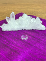 Load image into Gallery viewer, Your basic clear plastic ring to display crystal spheres or eggs. Use to keep your crystal spheres and eggs in place, rather than rolling off your altar, table or nightstand - lol.  This is the smallest size I offer at approximately 0.6&quot;x0.24&quot; (d/h). The 3rd photo shows all three available sizes.  Check out my crystal spheres and my ruby-in-matrix eggs and Judy Hall&#39;s The Crystal Bible Books - they are awesome! Cost is 25 cents and can only be purchased as an add-on item.
