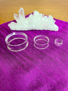 All 3 sizes. Your basic clear plastic ring to display crystal spheres or eggs. Use to keep your crystal spheres and eggs in place, rather than rolling off your altar, table or nightstand - lol. This is the smallest size I offer at approximately 0.6"x0.24" (d/h). The 3rd photo shows all three available sizes. Check out my crystal spheres and my ruby-in-matrix eggs and Judy Hall's The Crystal Bible Books - they are awesome! Cost for small is 25 cents and can only be purchased as an add-on item.