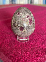 Load image into Gallery viewer, Display with crystal egg. Your basic clear plastic ring to display crystal spheres or eggs. Use to keep your crystal spheres and eggs in place, rather than rolling off your altar, table or nightstand - lol. This is the smallest size I offer at approximately 0.6&quot;x0.24&quot; (d/h). The 3rd photo shows all three available sizes. Check out my crystal spheres and my ruby-in-matrix eggs and Judy Hall&#39;s The Crystal Bible Books - they are awesome! Cost is 25 cents and can only be purchased as an add-on item.
