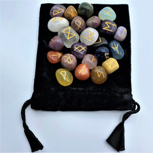 Mixed tumbled gemstone rune set with runic symbols on each stone in gold. Mixed tumbled stones means there will be a variety of gemstones, not just one type. There is no guarantee which stones will be included, but in this photo there are some amethyst, clear quartz, carnelian and more - very visually appealing. The runes come in a velvet bag with a paper sheet of rune meanings. 