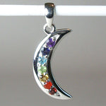 Load image into Gallery viewer, Another close-up view of the Chakra crescent moon pendant. Small faceted stones represent each of the chakras: amethyst/crown, iolite/third eye, blue topaz/throat, peridot/heart, citrine/solar plexus, carnelian/sacral (or naval), garnet/root (or base). These small, faceted stones are set, in a curve, along a solid sterling crescent moon. Pendant is approximately 1¼&quot;.
