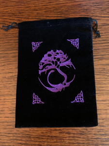 Close-up view of front of bag. Lovely Oracle deck/tarot bag with drawstrings for closure. Purple embroidered Tree of Life sits in the middle of the black faux-velvet bag with four other Celtic designs above and below to the left and right of the Tree. The 7"x5" bag fits most any size oracle deck but is best suited for larger cards (eg. Medicine Cards). Can also be used to store large crystals or other precious items. Cost is $7.50.
