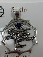 Load image into Gallery viewer, Close-up view of the sterling silver turtle spirit animal pendant with lapis gemstone (cab). The sea turtle is within a stylized circle, with the lapis gemstone above it. Wear your spirit animal on your chest and have it wherever you go! Pendant only - necklace chain not included.
