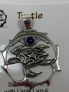 Close-up view of the sterling silver turtle spirit animal pendant with lapis gemstone (cab). The sea turtle is within a stylized circle, with the lapis gemstone above it. Wear your spirit animal on your chest and have it wherever you go! Pendant only - necklace chain not included.